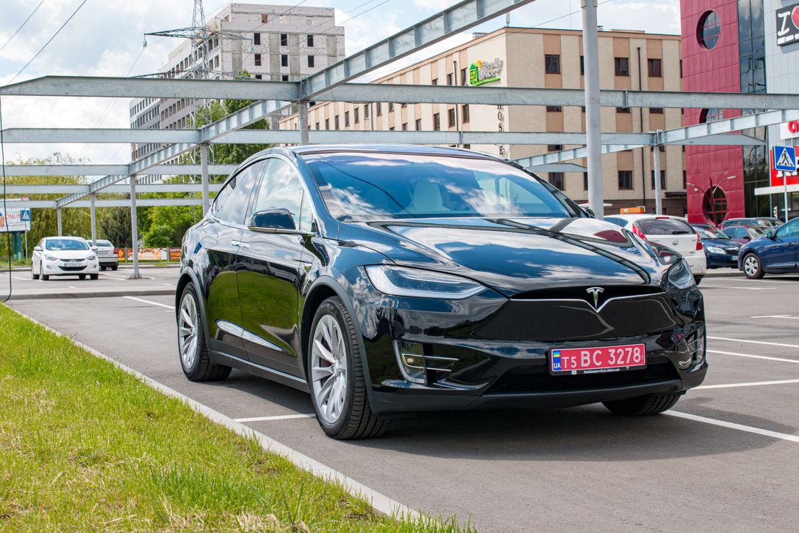 Black Tesla Model X parked in a city lot